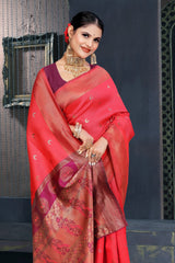 A red and pink Banarasi Dola silk saree with zari print, suitable for festive wear.