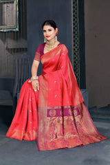 A red and pink Banarasi Dola silk saree with zari print, suitable for festive wear.