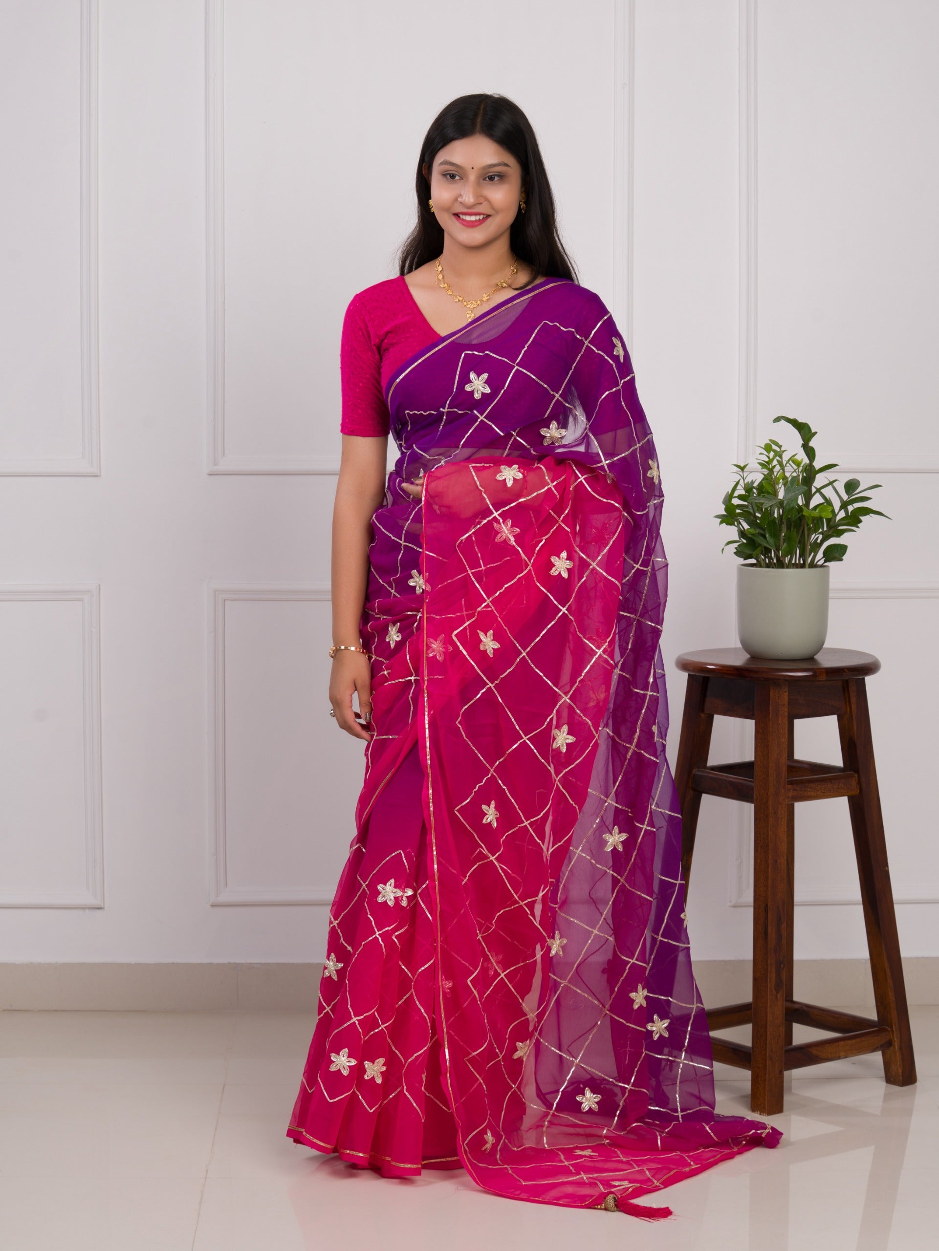 A pink and purple saree with a white pattern under 1000