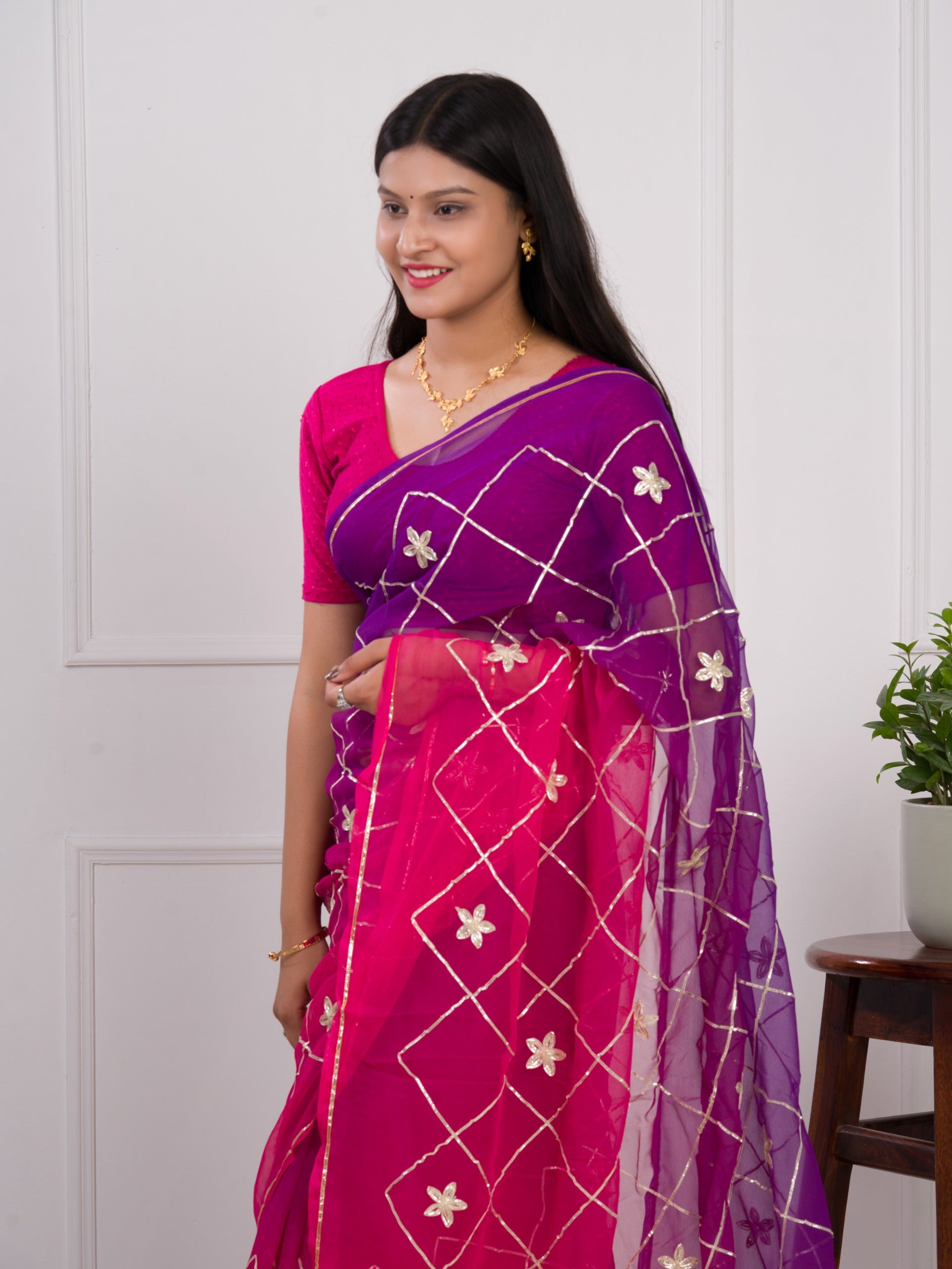 A pink and purple saree with a white pattern under 1000