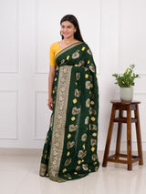 A green Dola silk saree with multi-colored bandhani style and Zari weaving work