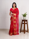 A red saree with gold patternsin Georgette Bandhani Style Saree
