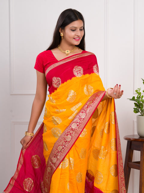 A yellow and red saree with  Pure Georgette Zari Faag Shadded Saree