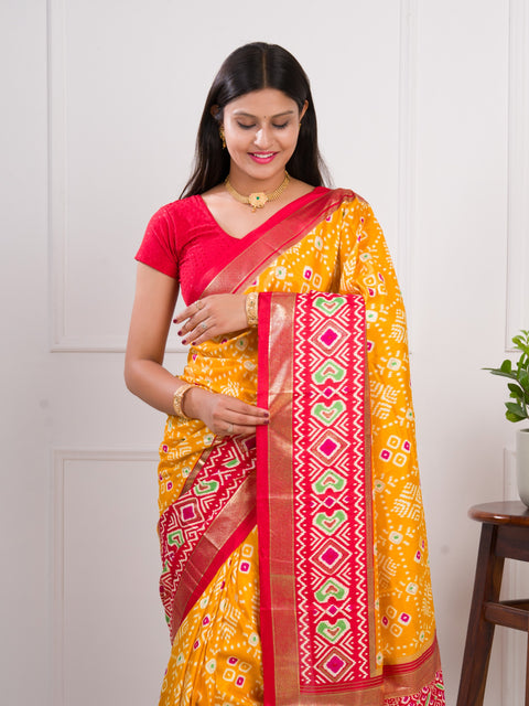  A yellow and red pashmina cotton silk saree with a patola style pattern 