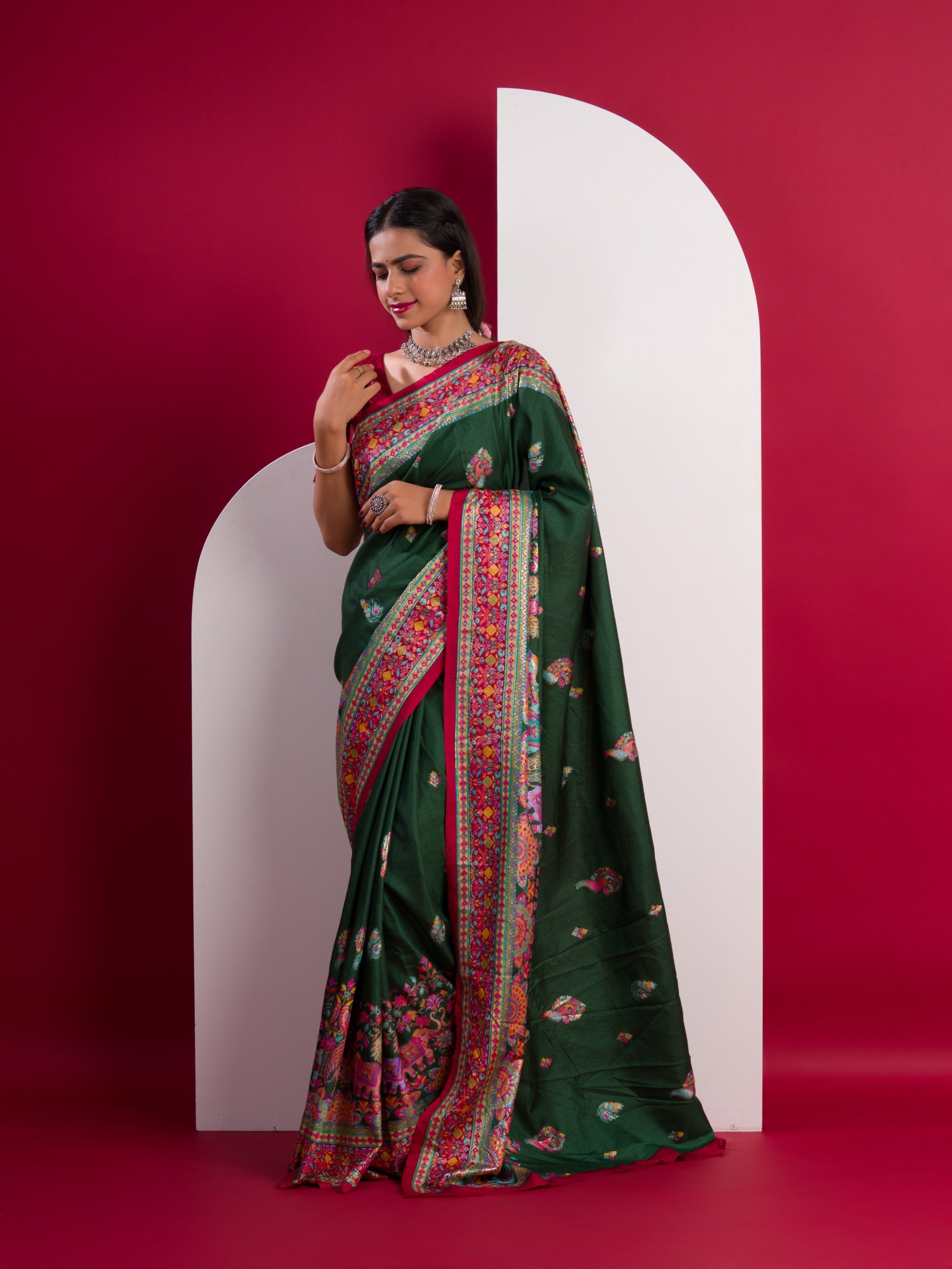 A green saree with a colorful borderin Dola Silk KalamkariStyle