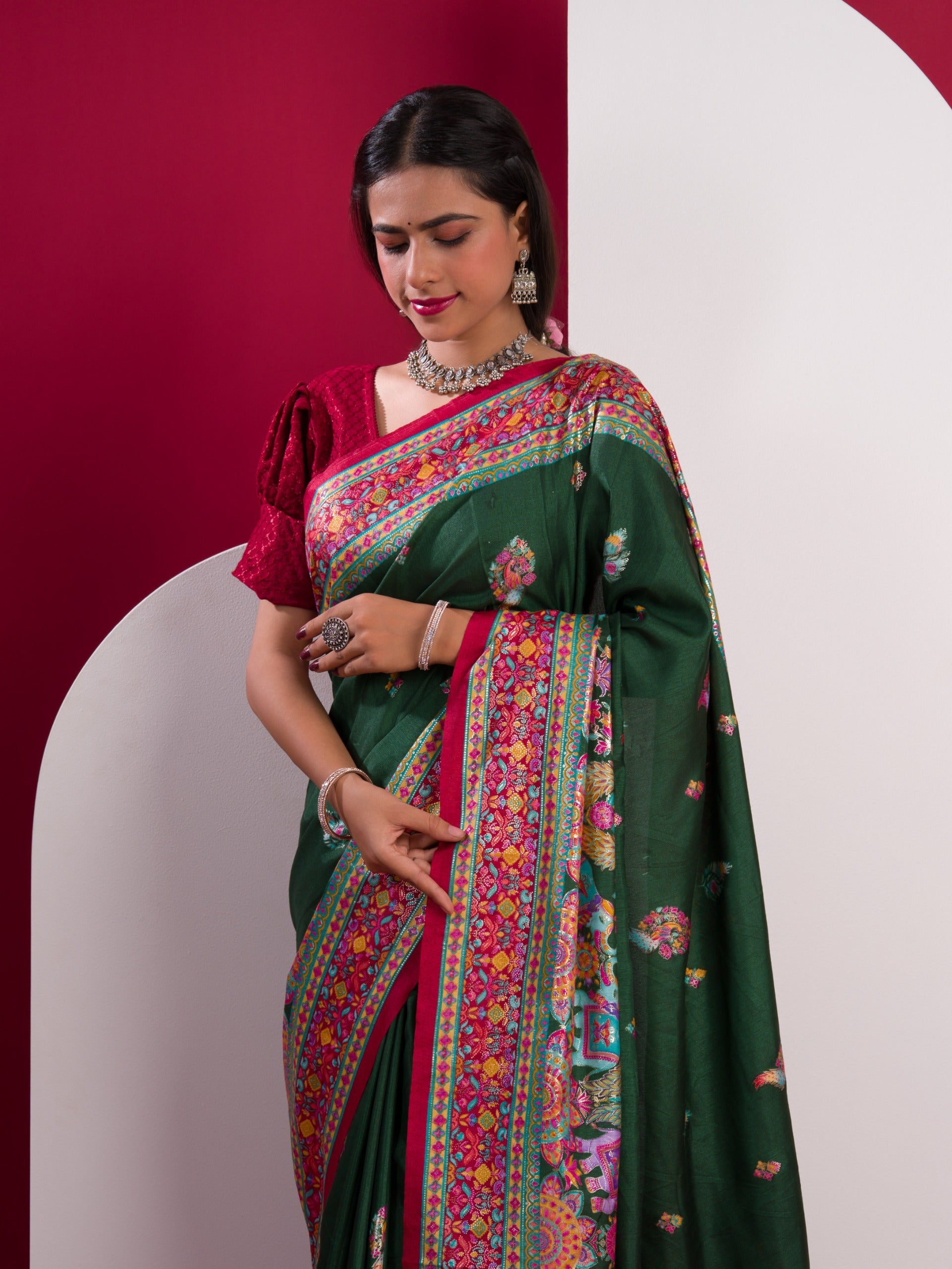 A green saree with a colorful borderin Dola Silk KalamkariStyle