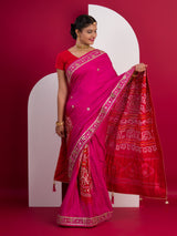 A pink saree with a red and gold border 
