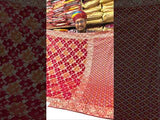 A Banarasi style saree with red and gold patterns and cutdana embellishments