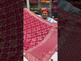 A Banarasi style saree with cutdana work, predominantly pink with gold geometric patterns