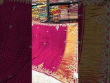 A pink modal silk saree with bandhani pattern and gotapatti work