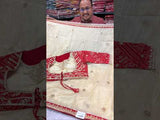 A red and white tissue silk saree with Bollywood style embellishments and gotapatti work.