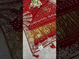 A red saree with white bandhani (dot) pattern and gotapatti border, 