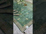 A sea green Banarasi silk saree with Bollywood style embellishments including sequins and gotapatti work