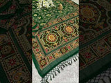 A green saree with traditional Jaipuri Rajwadi style embroidery and bandhani patterns, including real vintage mirror work.
