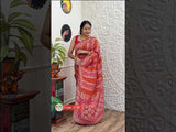A red and orange Banarasi saree with geometric patterns and zari weaving details.