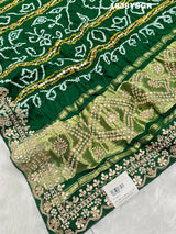 A green and gold pure Gaji silk bandhani gharchola saree with floral patterns and gota patti 