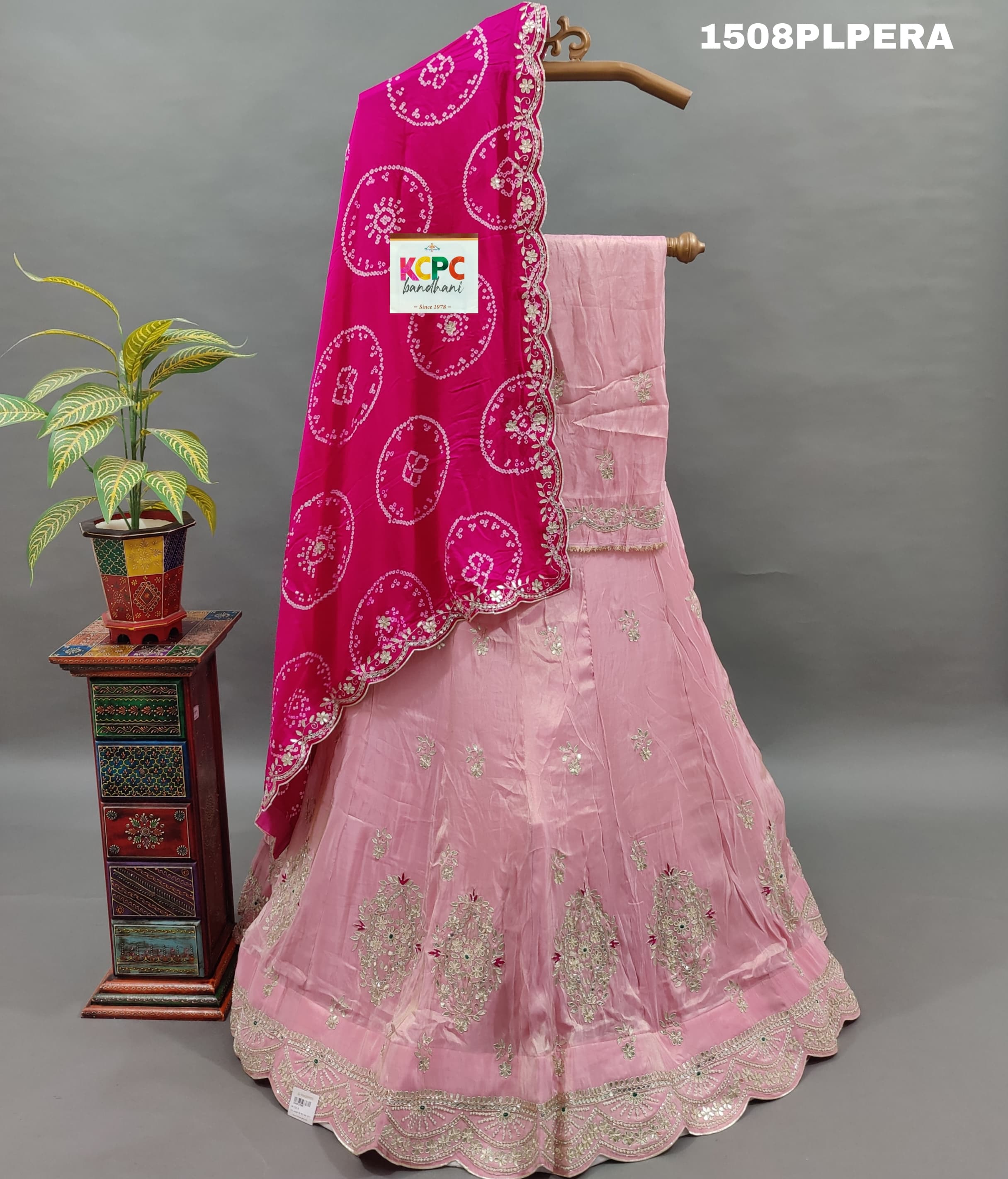 A pink silk lehenga with dupatta and cutdana work