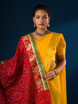 Ared and yellow traditional chunri dupatta with floral and geometric patterns and yellow embellishments.