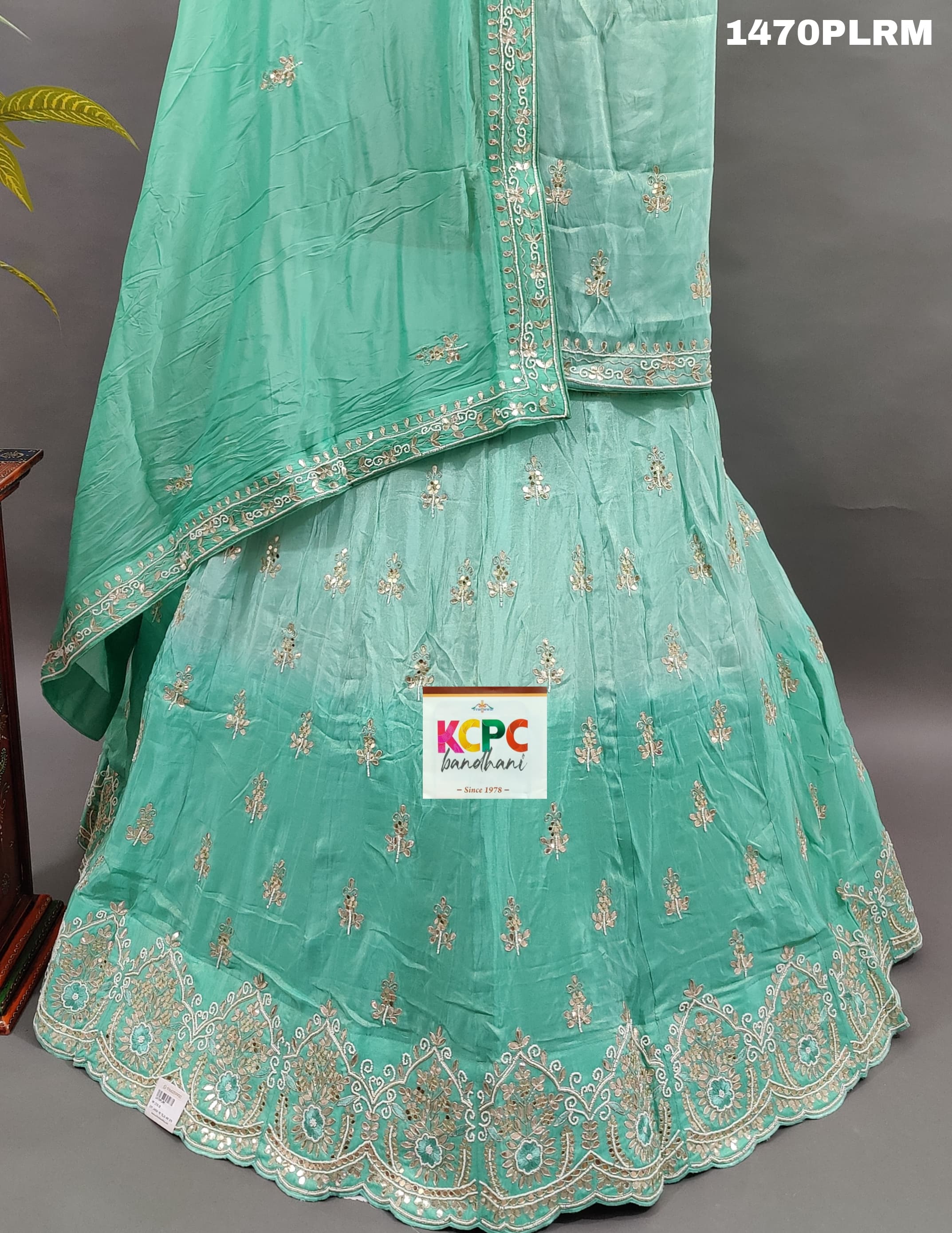 A green H O silk double shade heavy cutdana mirror work lehenga 
