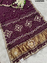 A purple and gold saree with gota patti work