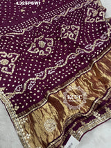A purple and gold saree with gota patti work
