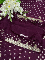 A purple and gold saree with gota patti work