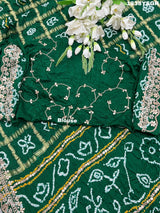 A green and gold pure Gaji silk bandhani gharchola saree with floral patterns and gota patti 
