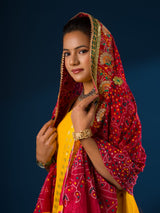 Ared and yellow traditional chunri dupatta with floral and geometric patterns and yellow embellishments.